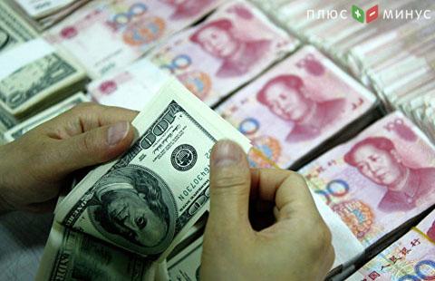 Китайский ЦБ повысил курс юаня к доллару на треть процента